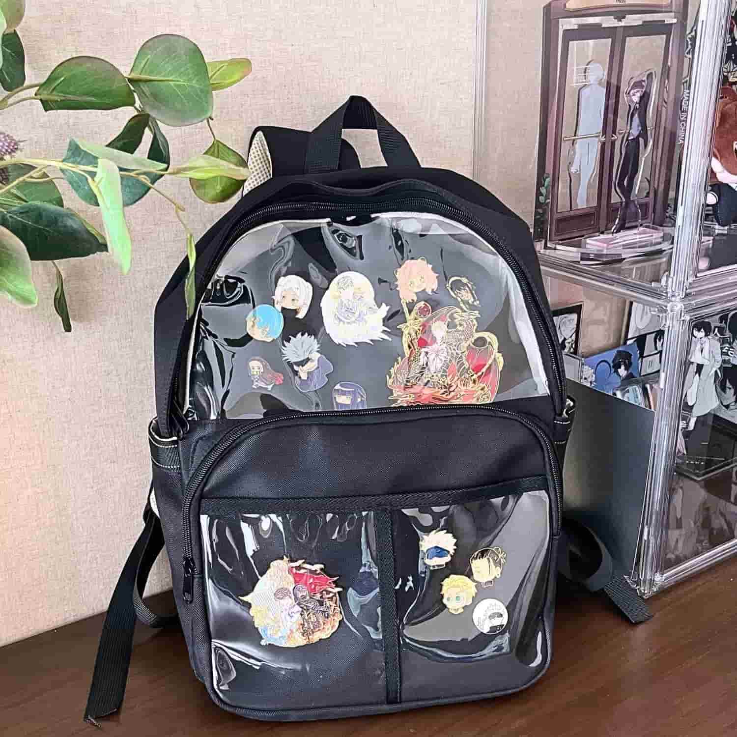 black ita backpack on table with enamel pin display inside clear window