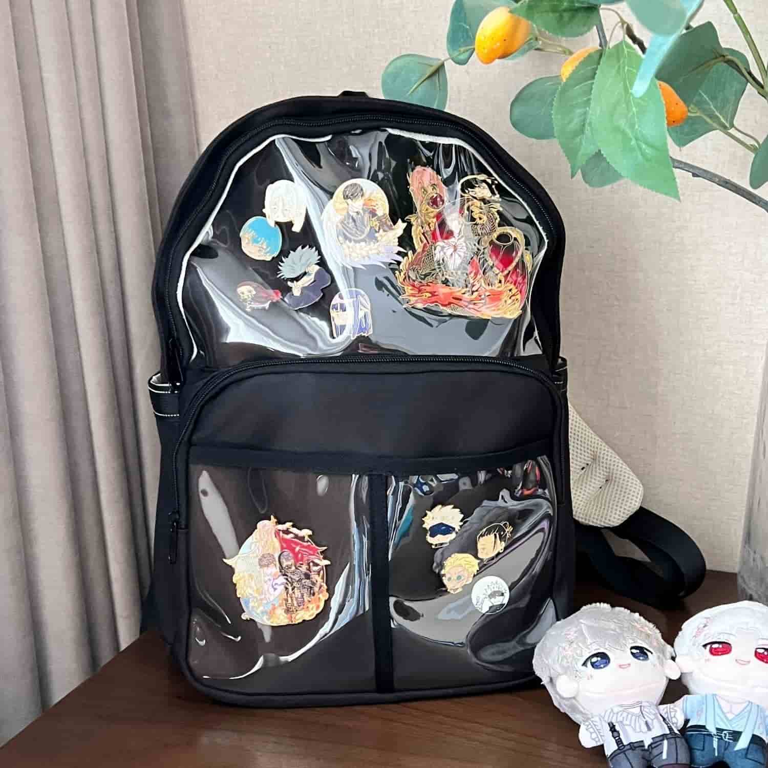 black ita backpack on table with enamel pin display inside clear window