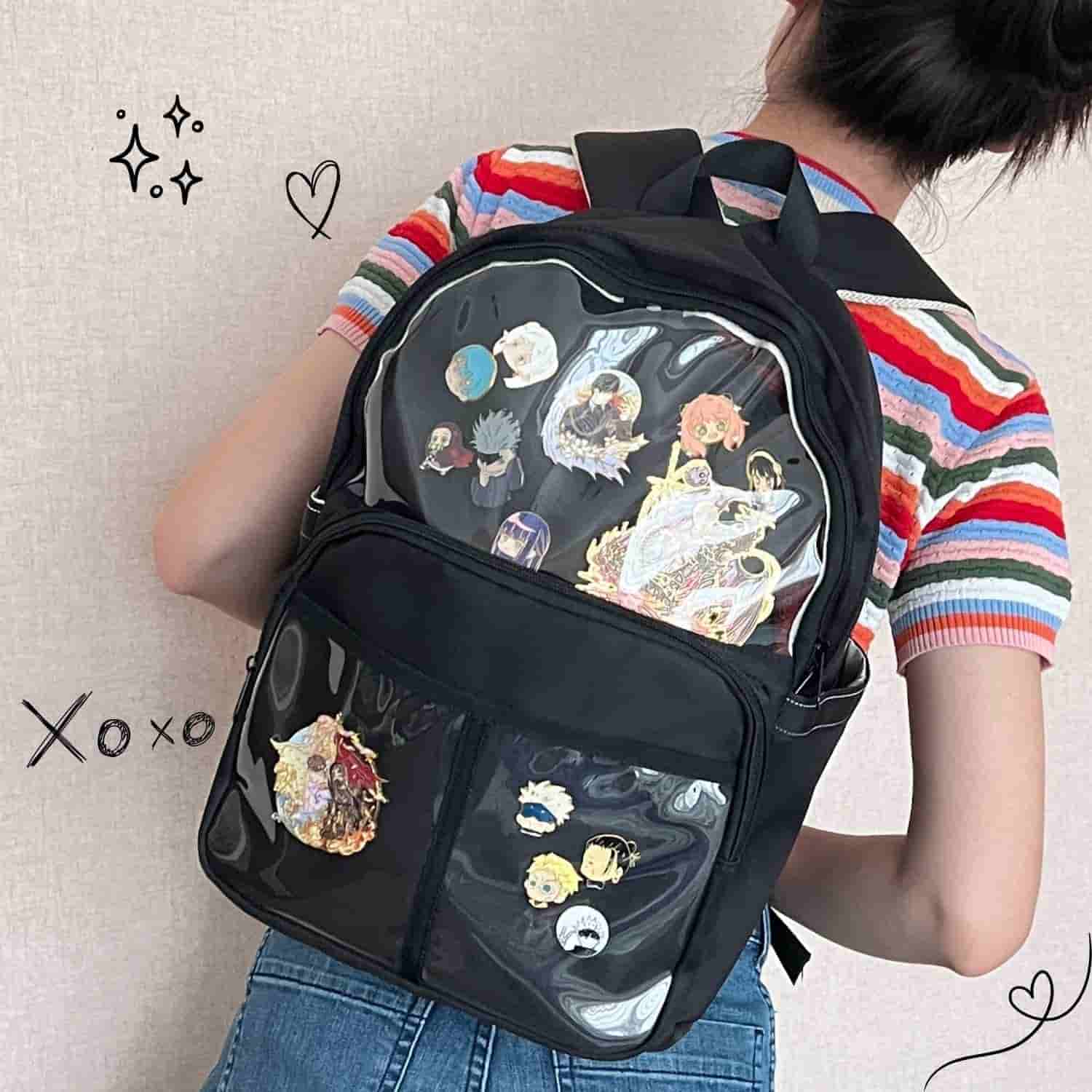 model wearing black ita backpack with enamel pins displayed in front window