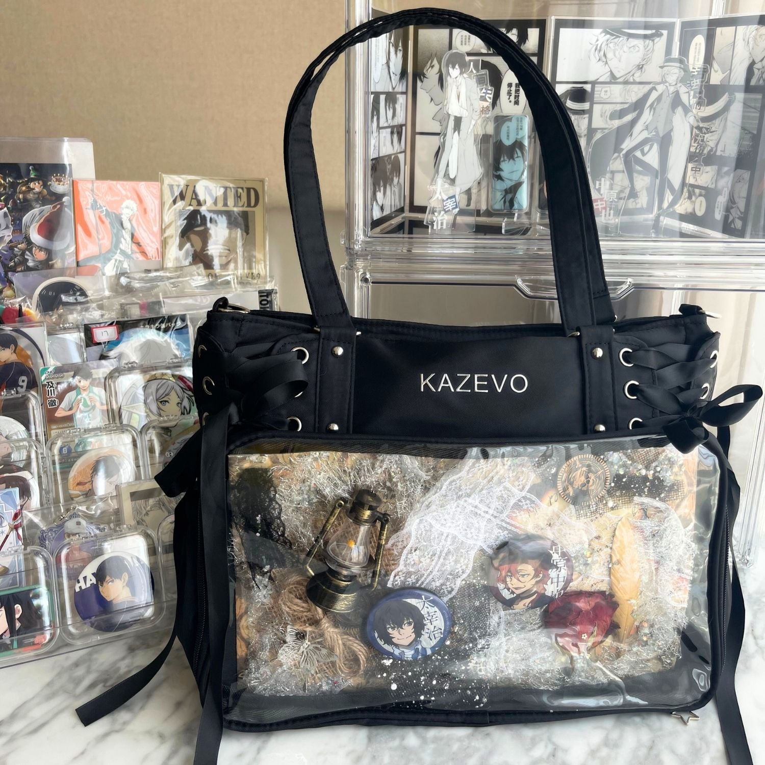 black ita bag on tabletop with anime Bungo Stray Dogs badges and pins display inside