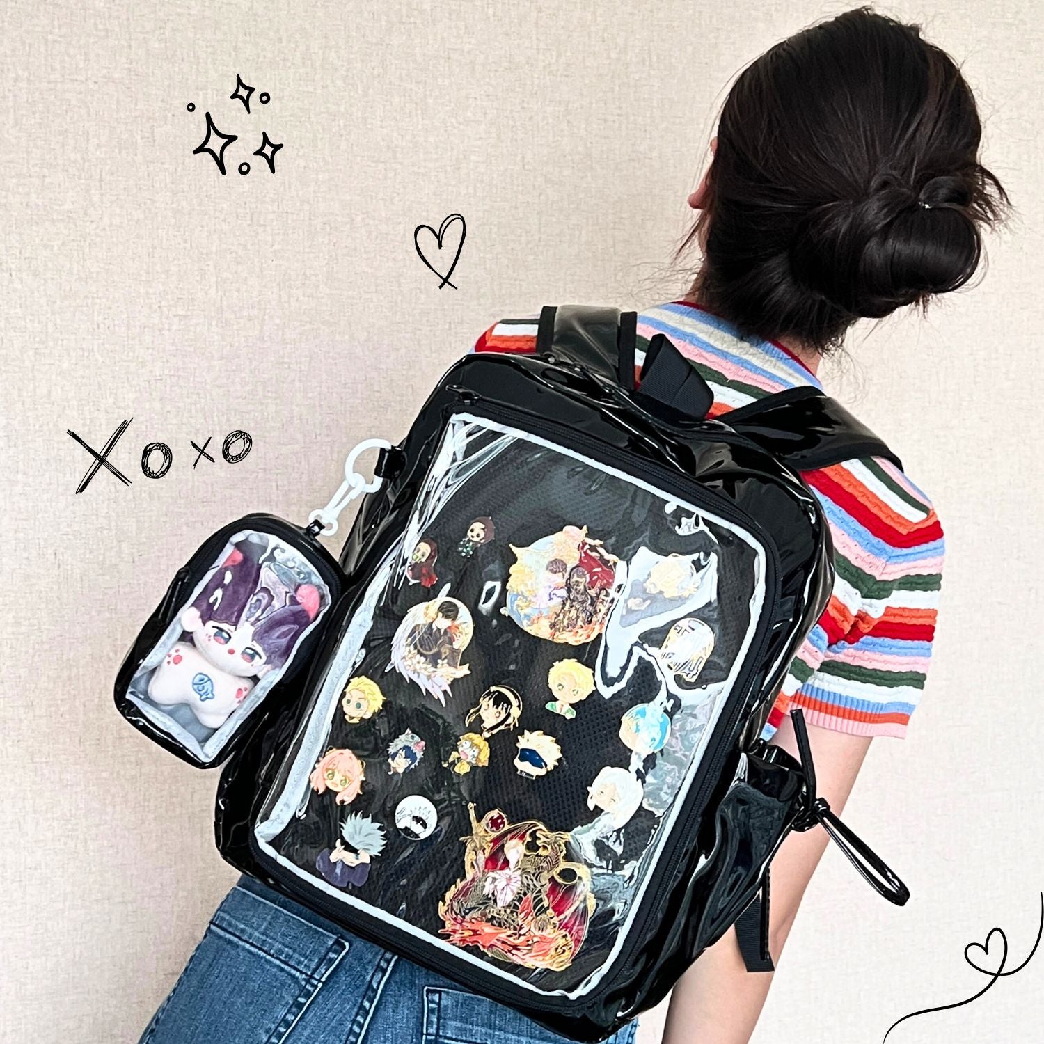 model wearing super large ita backpack featuring enamel pin display and plushie arrangement
