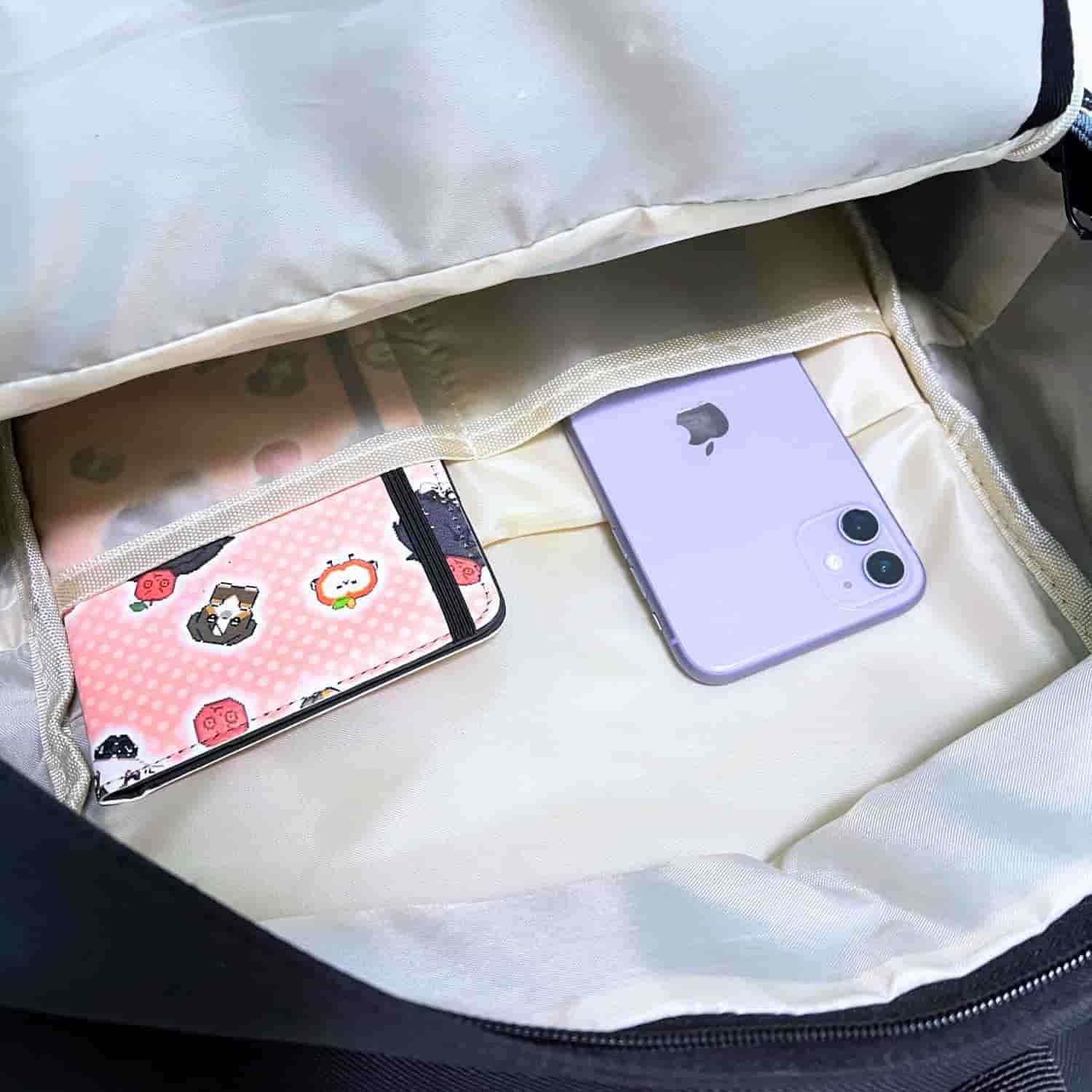 interior view of large ita backpack showing organized inner pockets for phone, notebook, and essentials