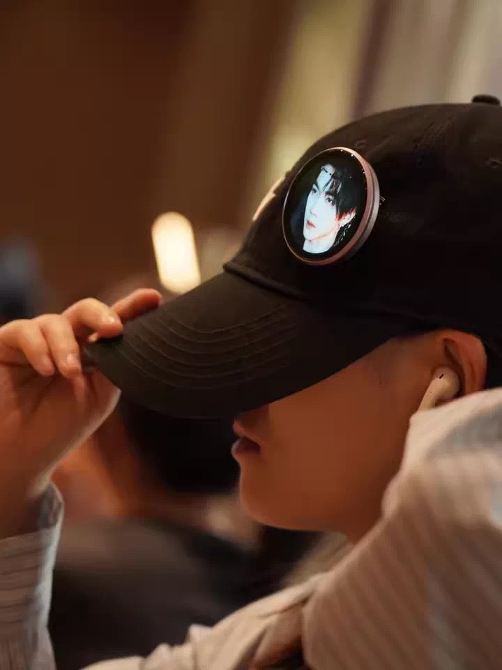 electronic button pin attached to a hat